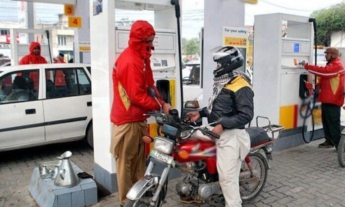 Pakistani bike rider getting petrol at the fuel station